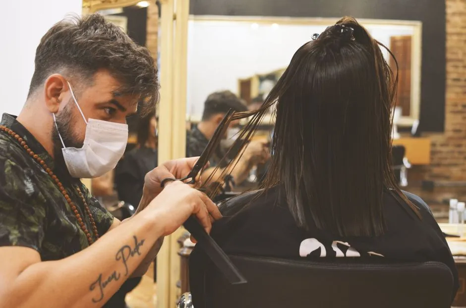 Barber trimming a client's hair at a walk-in salon